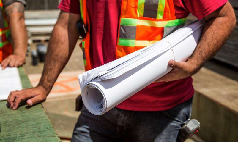 Engineer reviewing plans on site